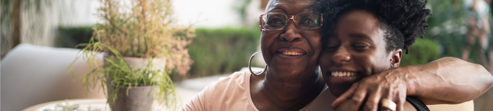 Grandmother with an arm around joyful grandaughter